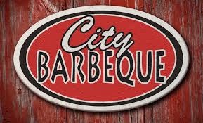 wood background with city bbq in a circle